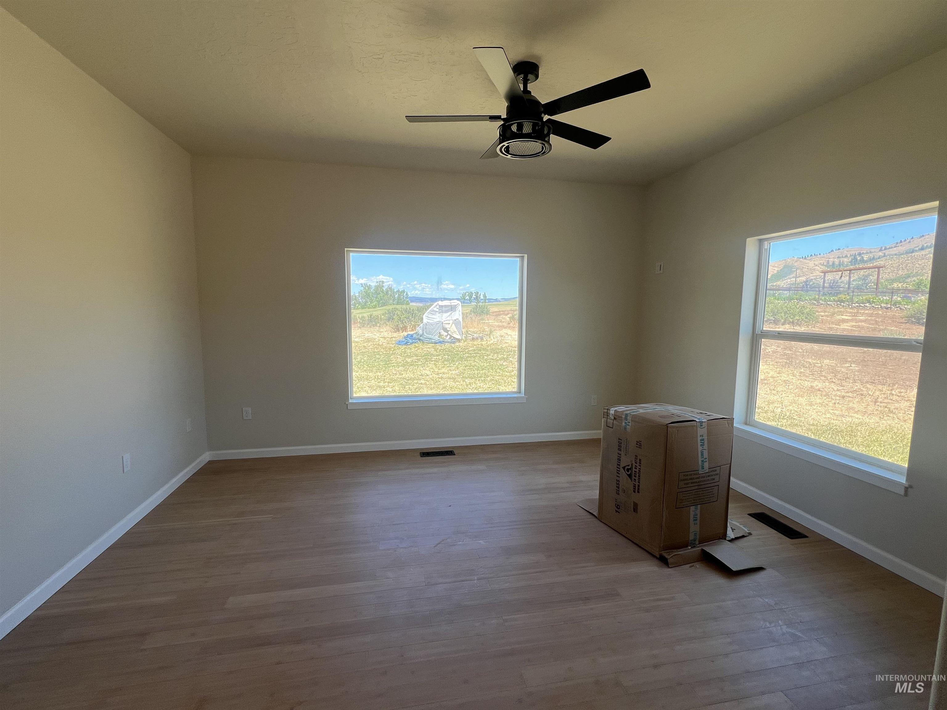 2300 Golf Council, ID 83612 - Photo 14 of 17 Spacious room featuring wood-finish flooring, neutral wall tones, and white trim
