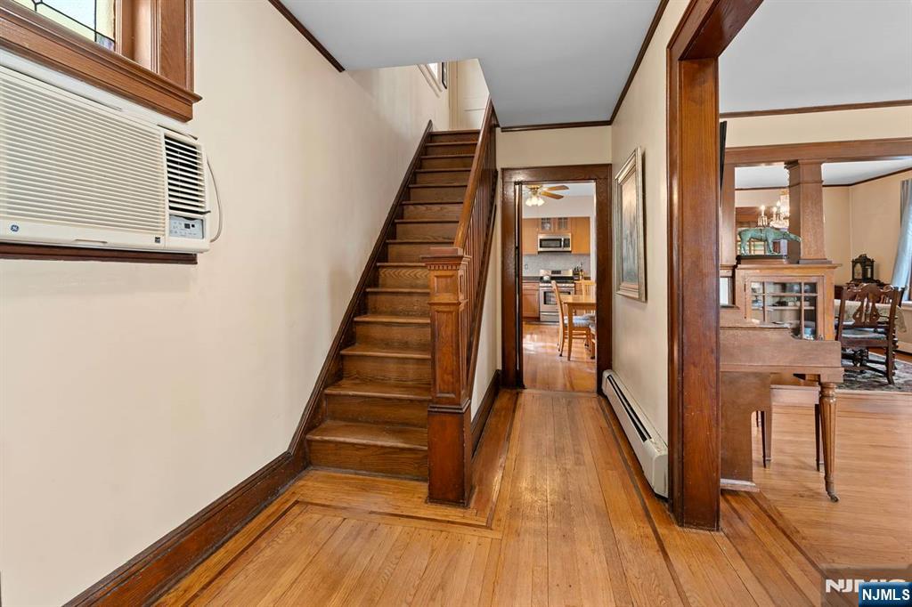 294 Sylvan Street Rutherford, NJ 07070 - Photo 14 of 29 a view of a hallway with wooden floor and staircase