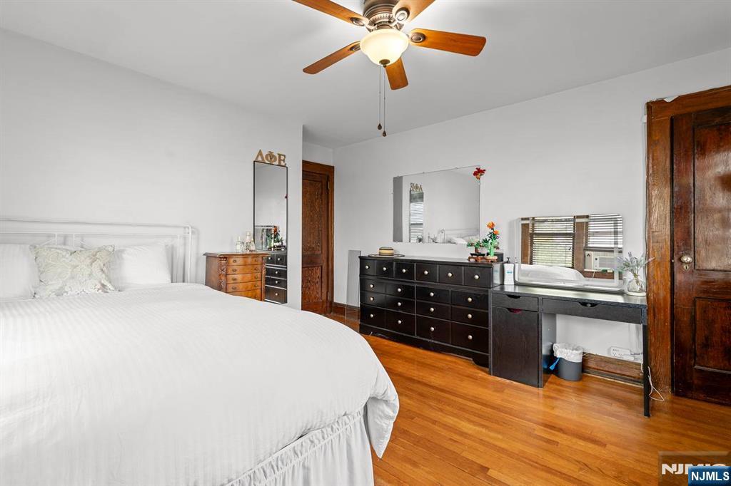 294 Sylvan Street Rutherford, NJ 07070 - Photo 15 of 29 a bedroom with a bed and wooden floor