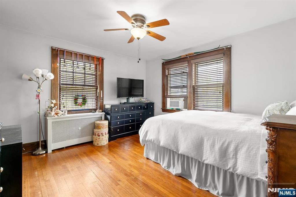 294 Sylvan Street Rutherford, NJ 07070 - Photo 16 of 29 a bedroom with a bed and a flat screen tv