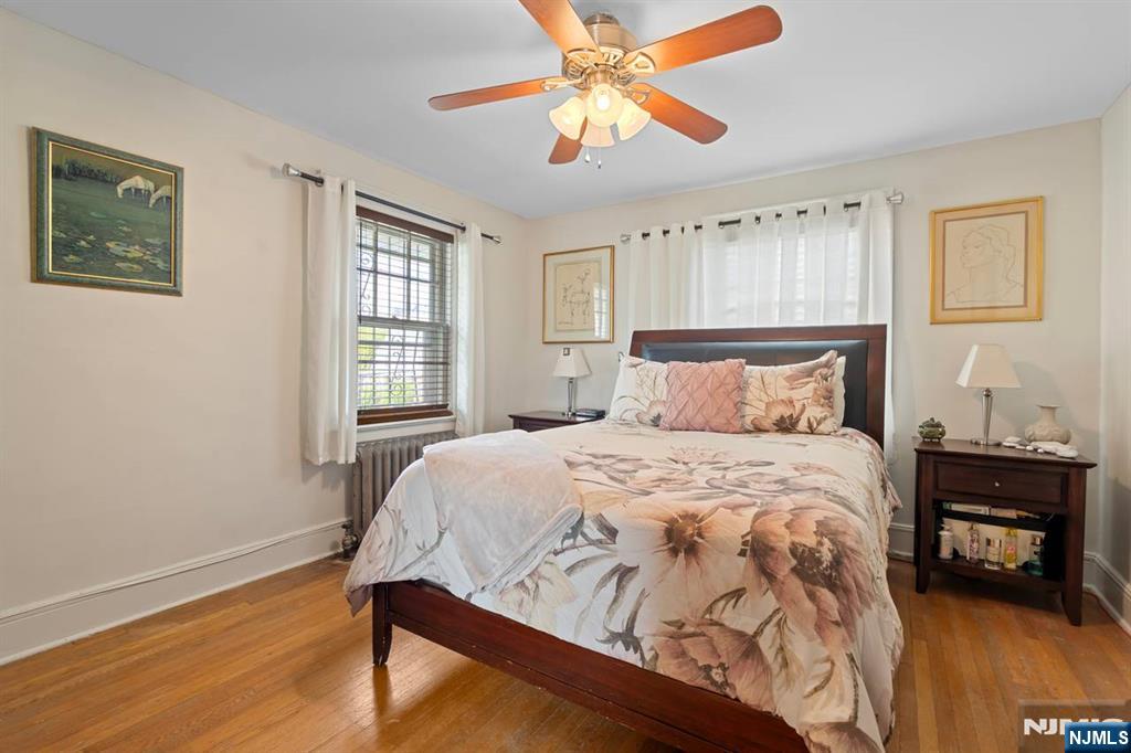 294 Sylvan Street Rutherford, NJ 07070 - Photo 17 of 29 a bedroom with a bed and wooden floor