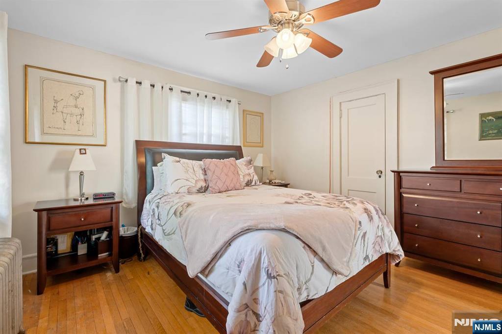 294 Sylvan Street Rutherford, NJ 07070 - Photo 18 of 29 a bedroom with a bed and a chandelier