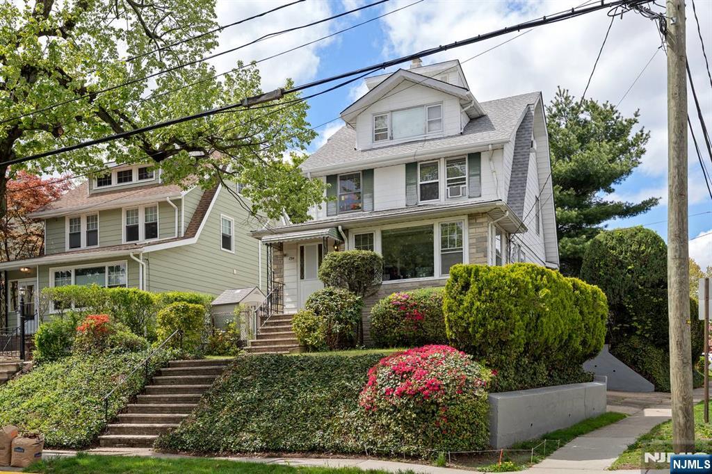 294 Sylvan Street Rutherford, NJ 07070 - Photo 2 of 29 a front view of a house with garden