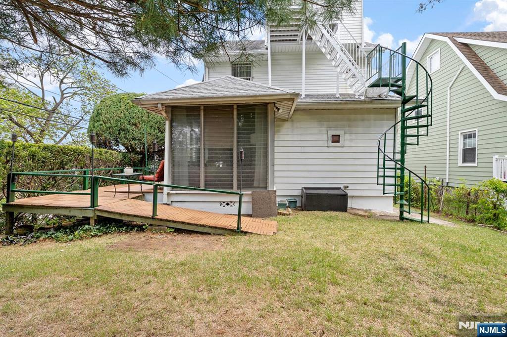 294 Sylvan Street Rutherford, NJ 07070 - Photo 24 of 29 a view of a house with a backyard and a chair
