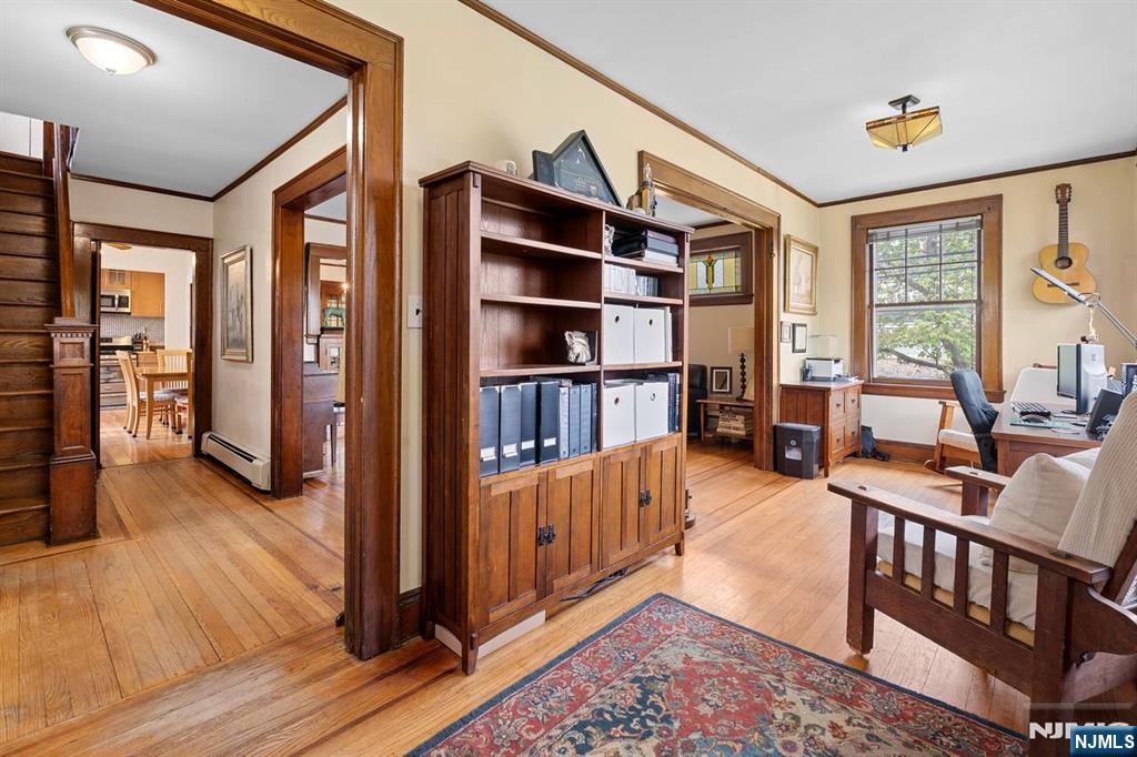 294 Sylvan Street Rutherford, NJ 07070 - Photo 5 of 29 a living room with furniture a rug and a book shelf
