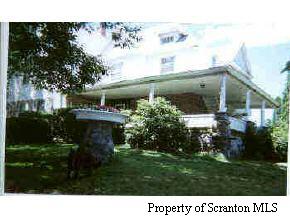 a view of house with a yard