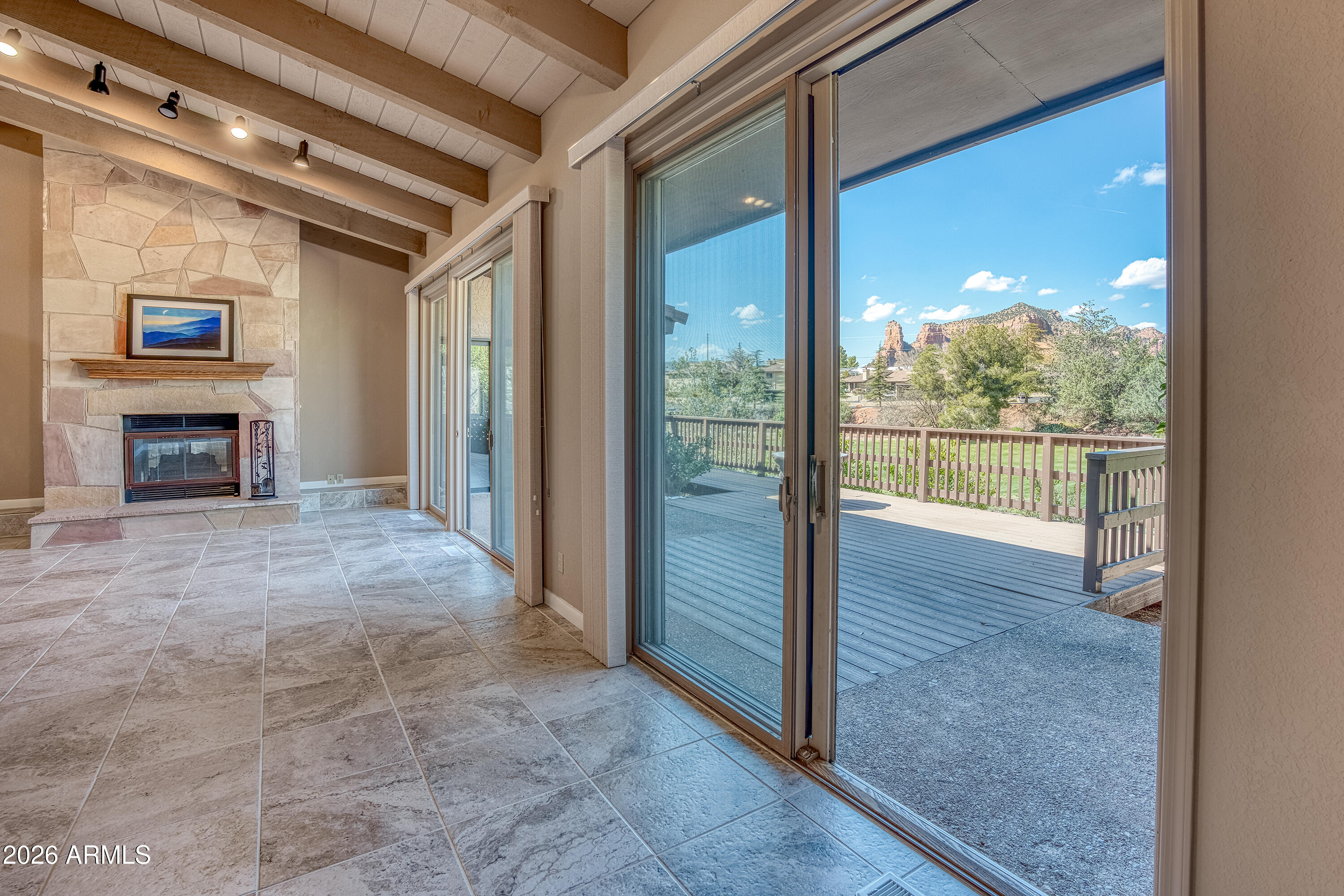 56 Red River Road Sedona, AZ 86351 - Photo 19 of 48 a view of a living room with a fireplace and a floor to ceiling window