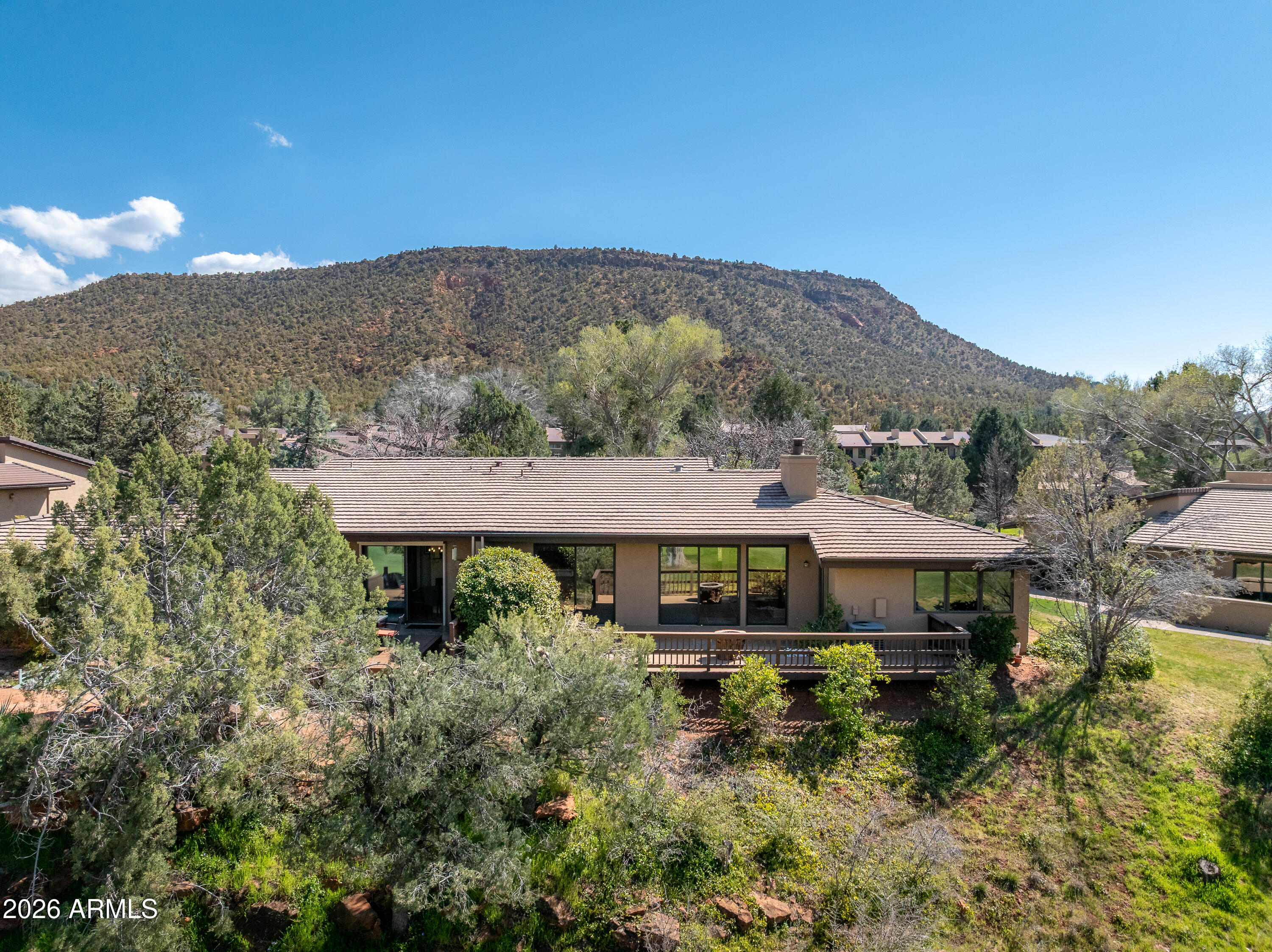 56 Red River Road Sedona, AZ 86351 - Photo 2 of 48 a front view of a house with a yard and mountain