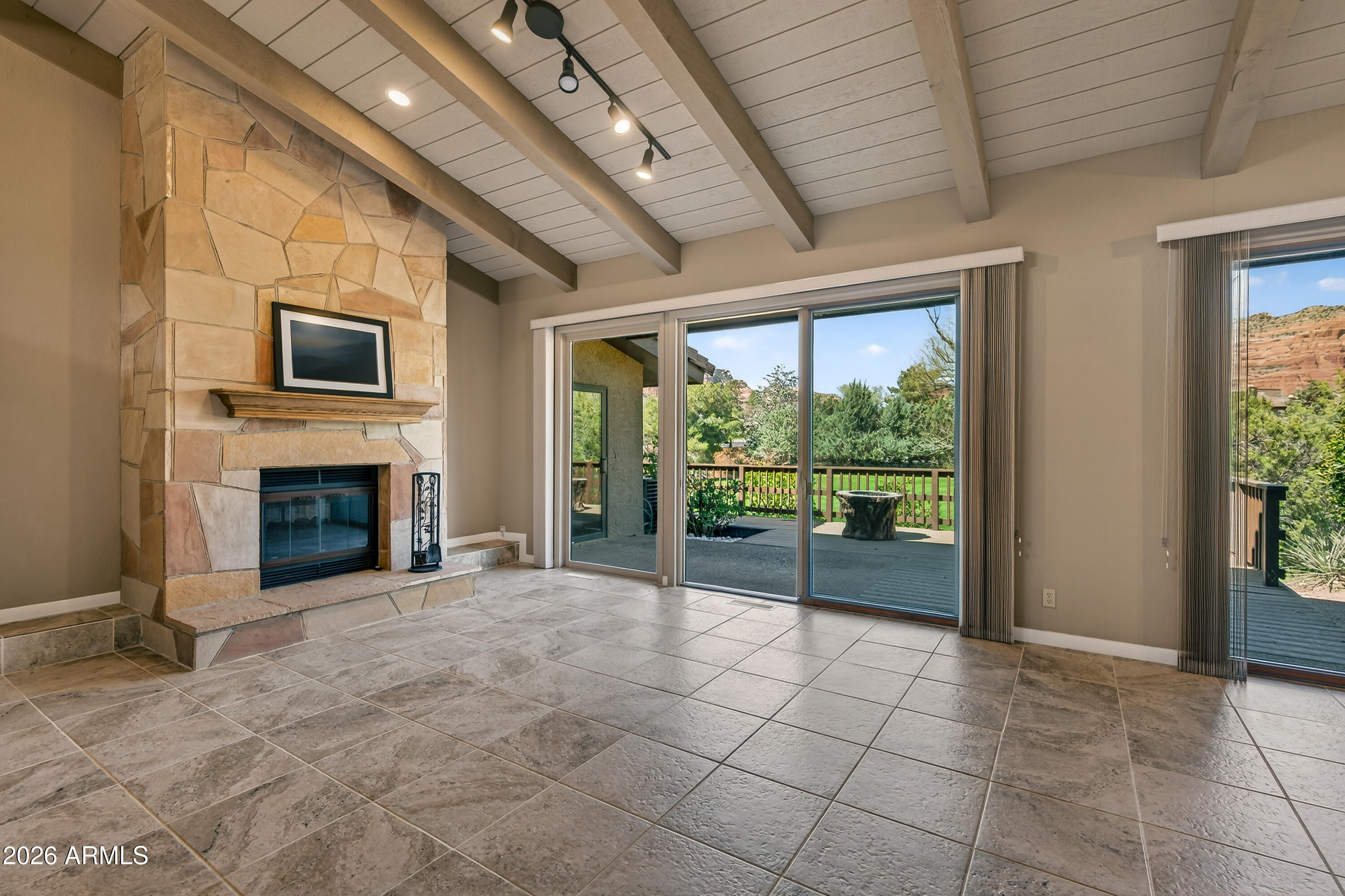 56 Red River Road Sedona, AZ 86351 - Photo 22 of 48 a view of an empty room with a fireplace and a window