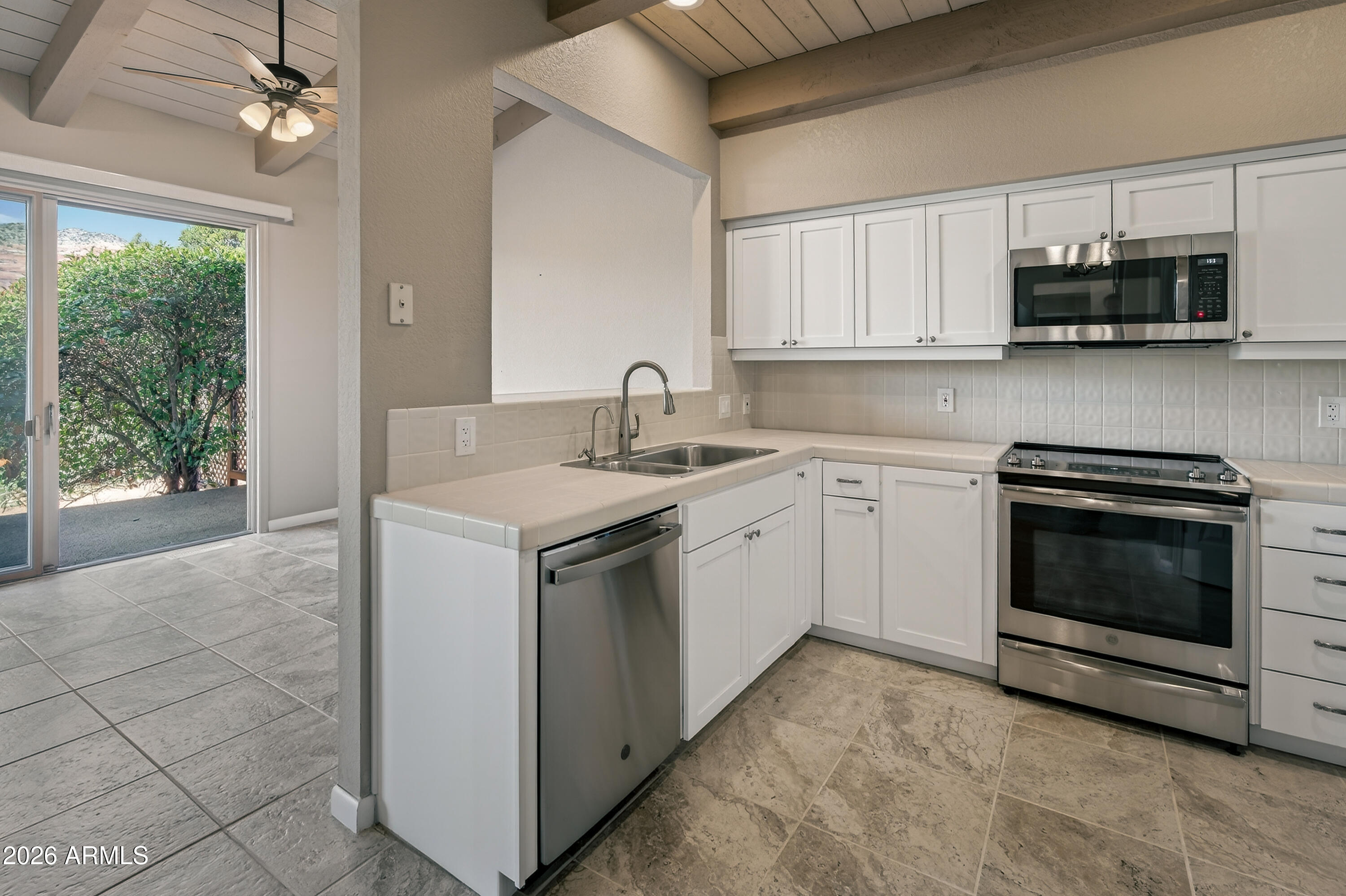 56 Red River Road Sedona, AZ 86351 - Photo 9 of 48 a kitchen with a sink stove and microwave