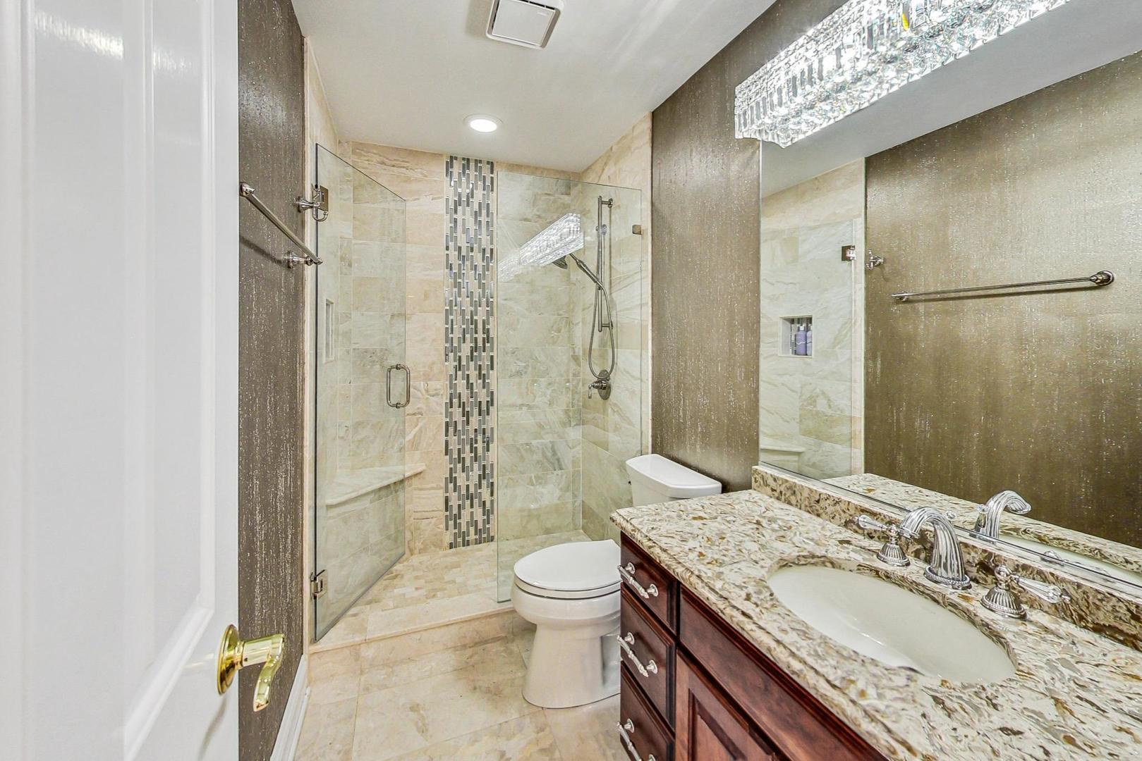 4454 Kettering Drive Long Grove, IL 60047 - Photo 25 of 44 a bathroom with a granite countertop sink toilet and shower