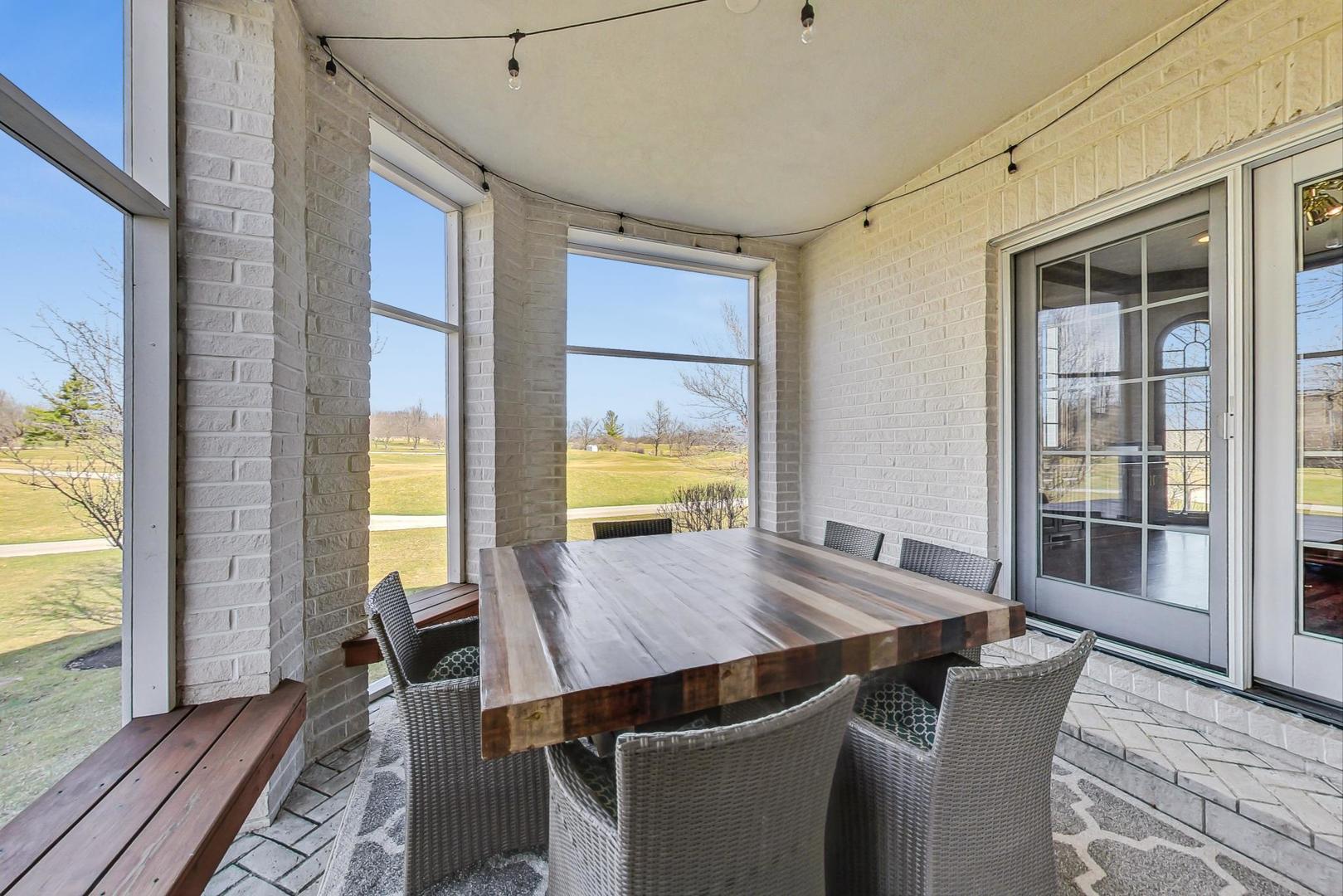 4454 Kettering Drive Long Grove, IL 60047 - Photo 34 of 44 a view of a dining room with furniture window and wooden floor