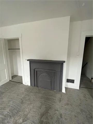 an empty room with a fireplace