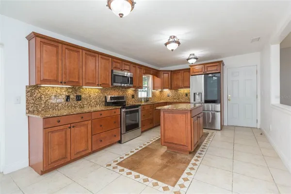 a kitchen with a sink window and cabinets