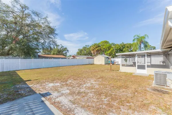 a view of a house with a backyard and a yard