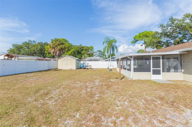 a view of a house with a yard and potted plants