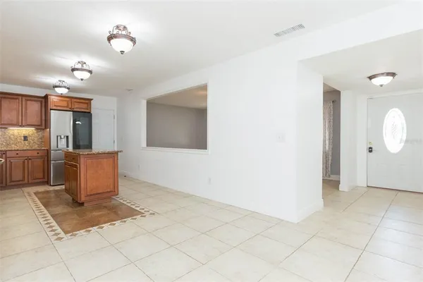 a view of a kitchen with wooden cabinets
