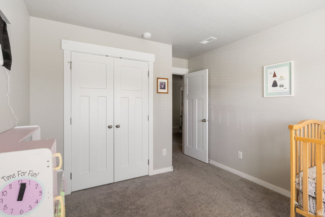 5155 East Rio Grande Way Eagle Mountain, UT 84005 - Photo 25 of 40 Carpeted bedroom featuring baseboards and a closet