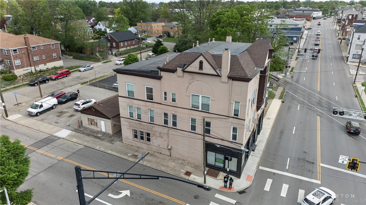 7045-7049 Montgomery Road Cincinnati, OH 45236 - Photo 7 of 68 An aerial view showcases this multi-level building with street access and surrounding urban landscape.