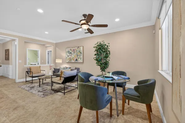 a view of a hallway with a chandelier fan and a livingroom
