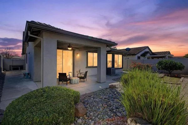 an aerial view of residential houses with outdoor space and trees