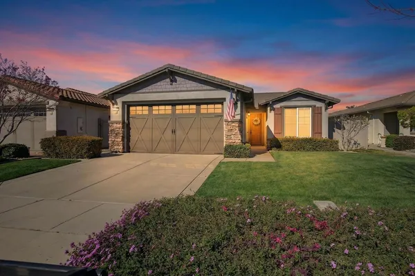 a front view of a house with garden