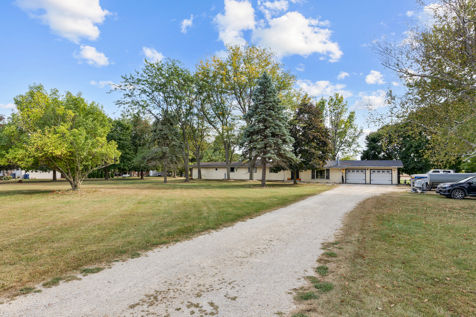 a view of a house with backyard and tree s