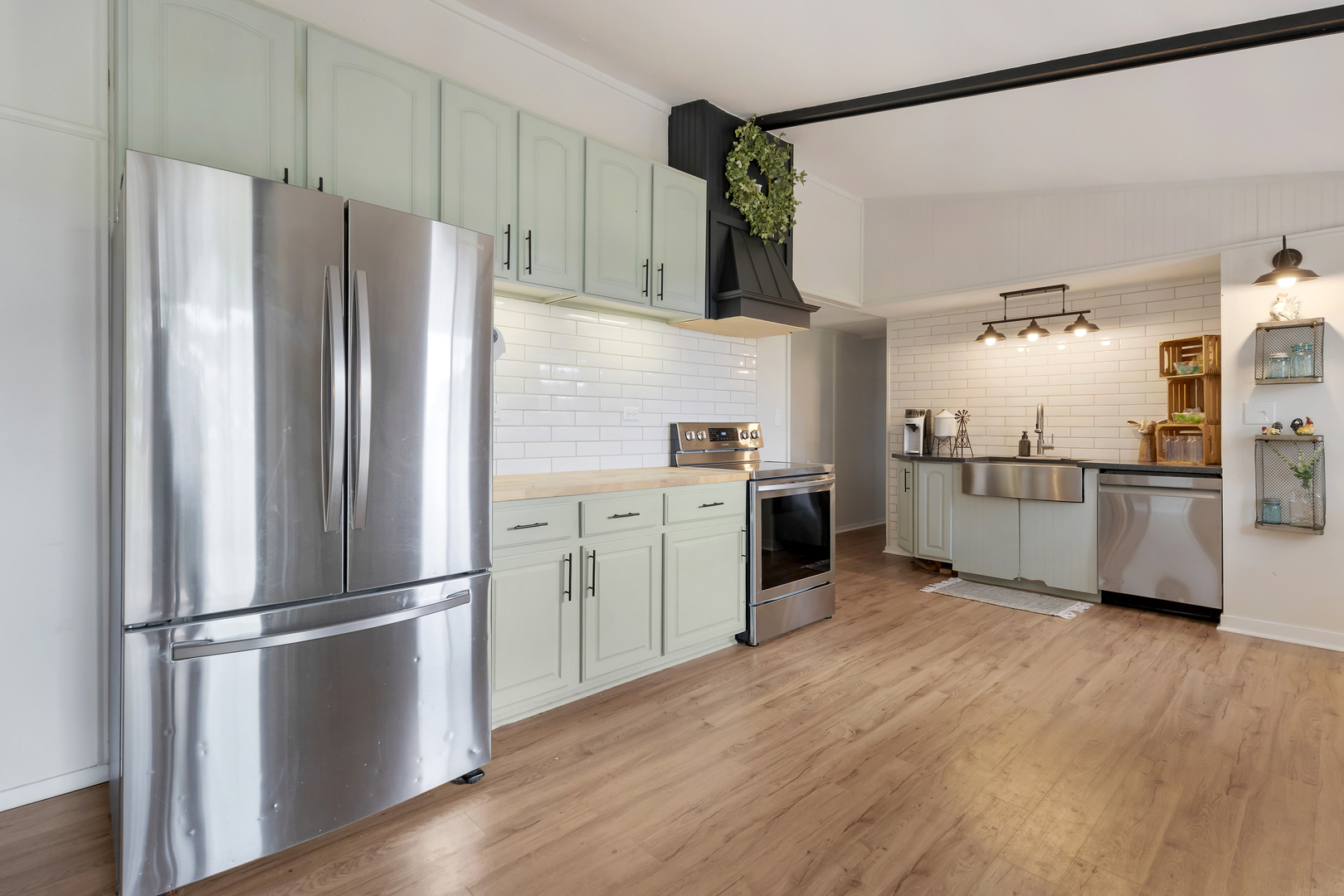 6610 Cherry Valley Road Kingston, IL 60145 - Photo 11 of 37 a kitchen with stainless steel appliances wooden floor sink and refrigerator