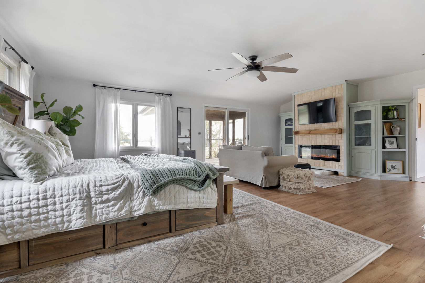 6610 Cherry Valley Road Kingston, IL 60145 - Photo 15 of 37 a spacious bedroom with a bed a fireplace and a couch