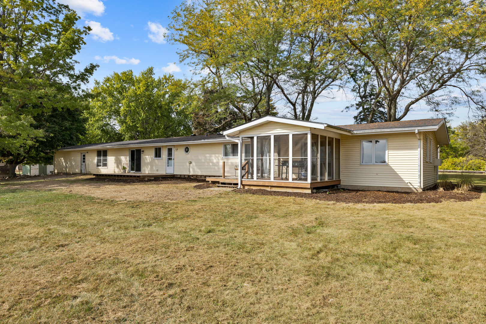 6610 Cherry Valley Road Kingston, IL 60145 - Photo 2 of 37 a front view of a house with a garden