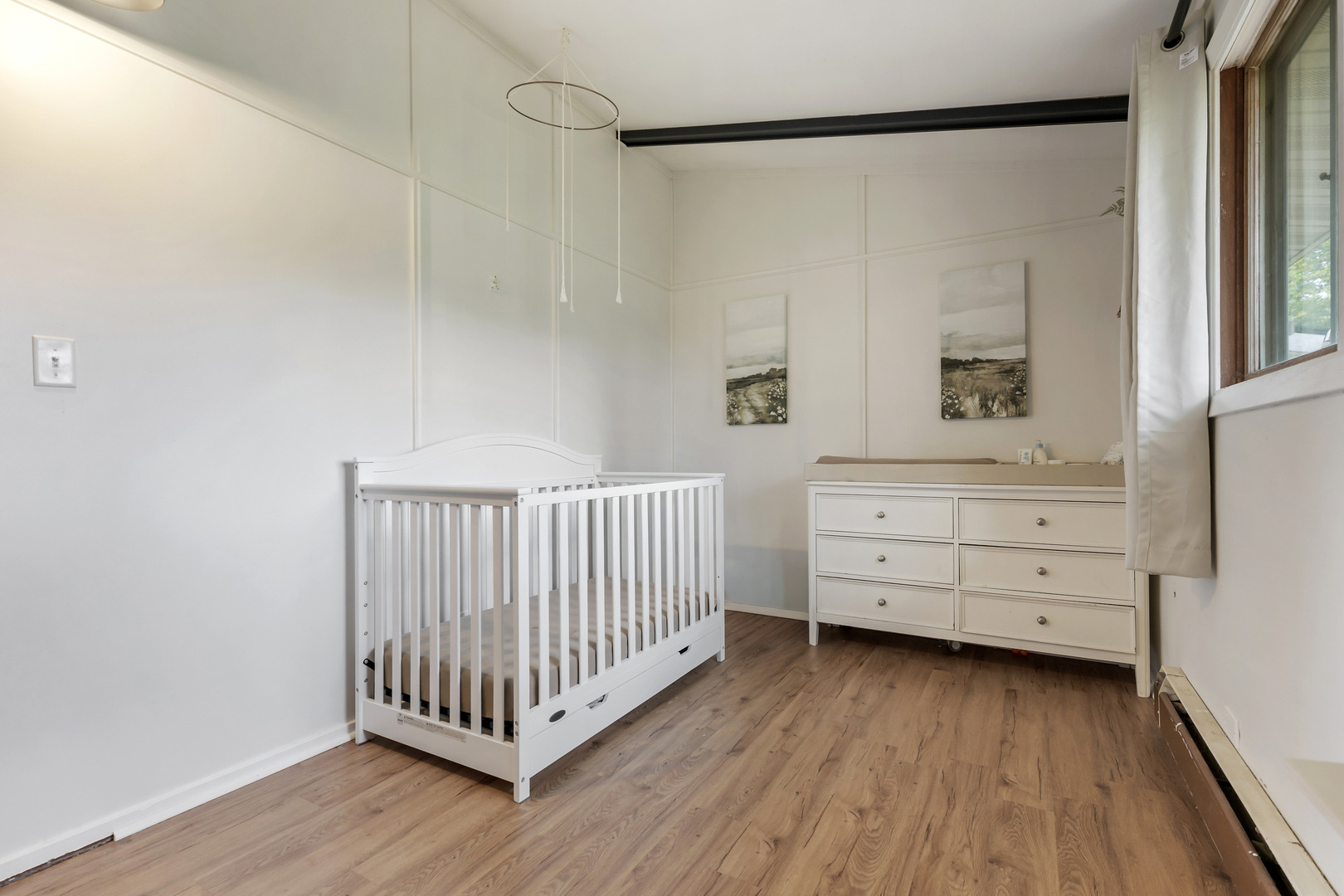 6610 Cherry Valley Road Kingston, IL 60145 - Photo 22 of 37 a room with a baby crib dresser and a window