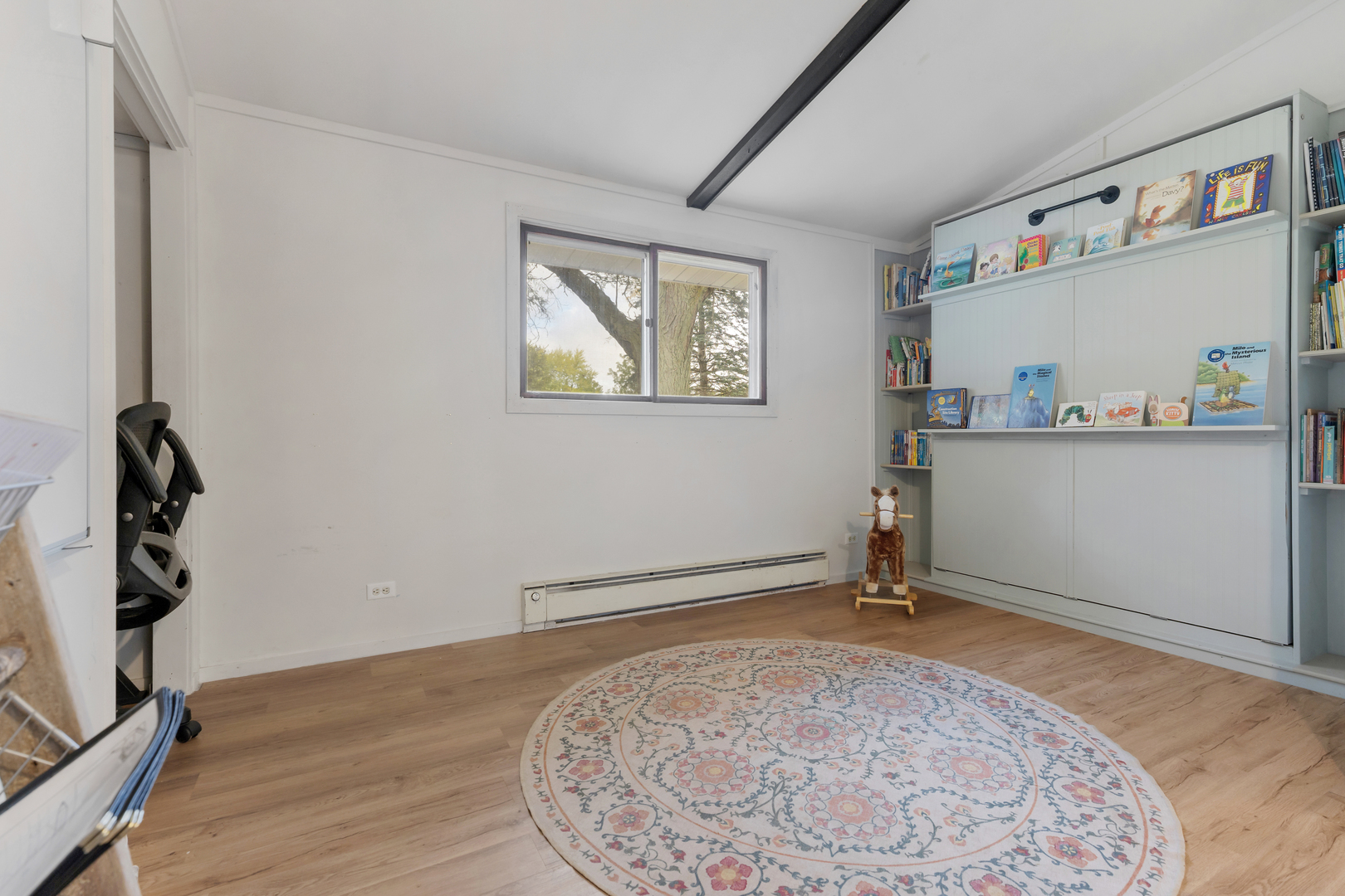 6610 Cherry Valley Road Kingston, IL 60145 - Photo 23 of 37 a view of a livingroom with wooden floor and a window