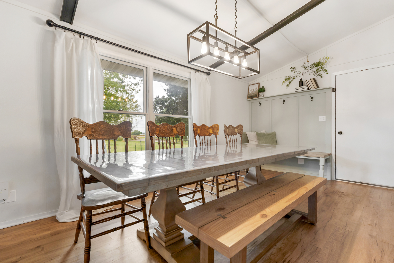 6610 Cherry Valley Road Kingston, IL 60145 - Photo 7 of 37 a dining room with furniture a chandelier and wooden floor