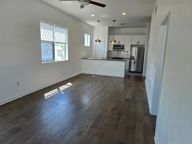 a view of kitchen with sink and wooden floor