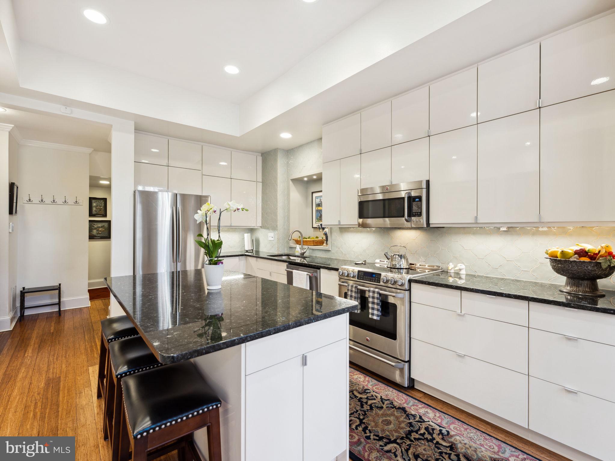 2001 19th Street Northwest, Unit 4 Washington, DC 20009 - Photo 13 of 42 a kitchen with stainless steel appliances granite countertop a sink stove and refrigerator