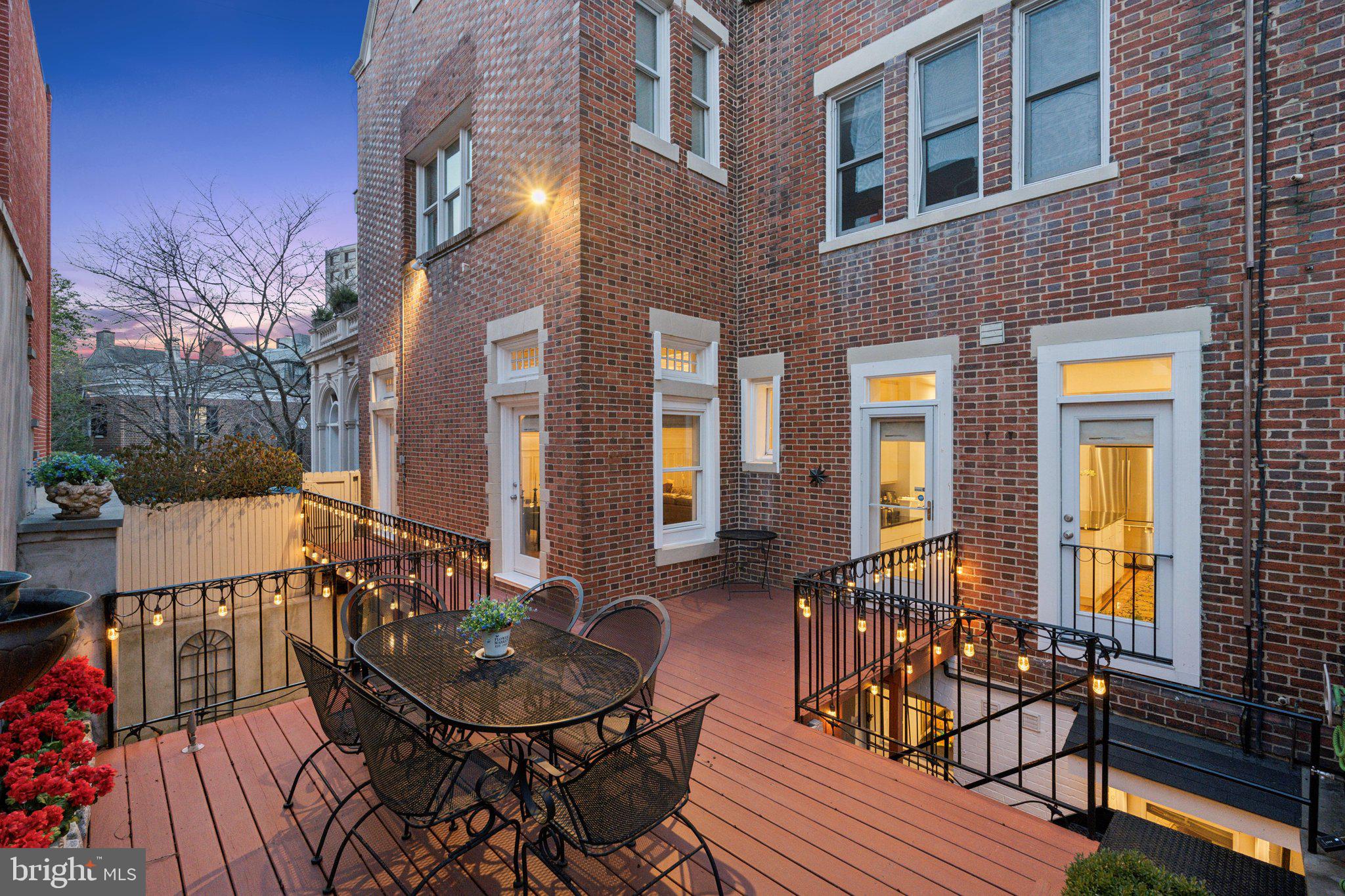 2001 19th Street Northwest, Unit 4 Washington, DC 20009 - Photo 16 of 42 a view of a patio with couches table and chairs and wooden floor