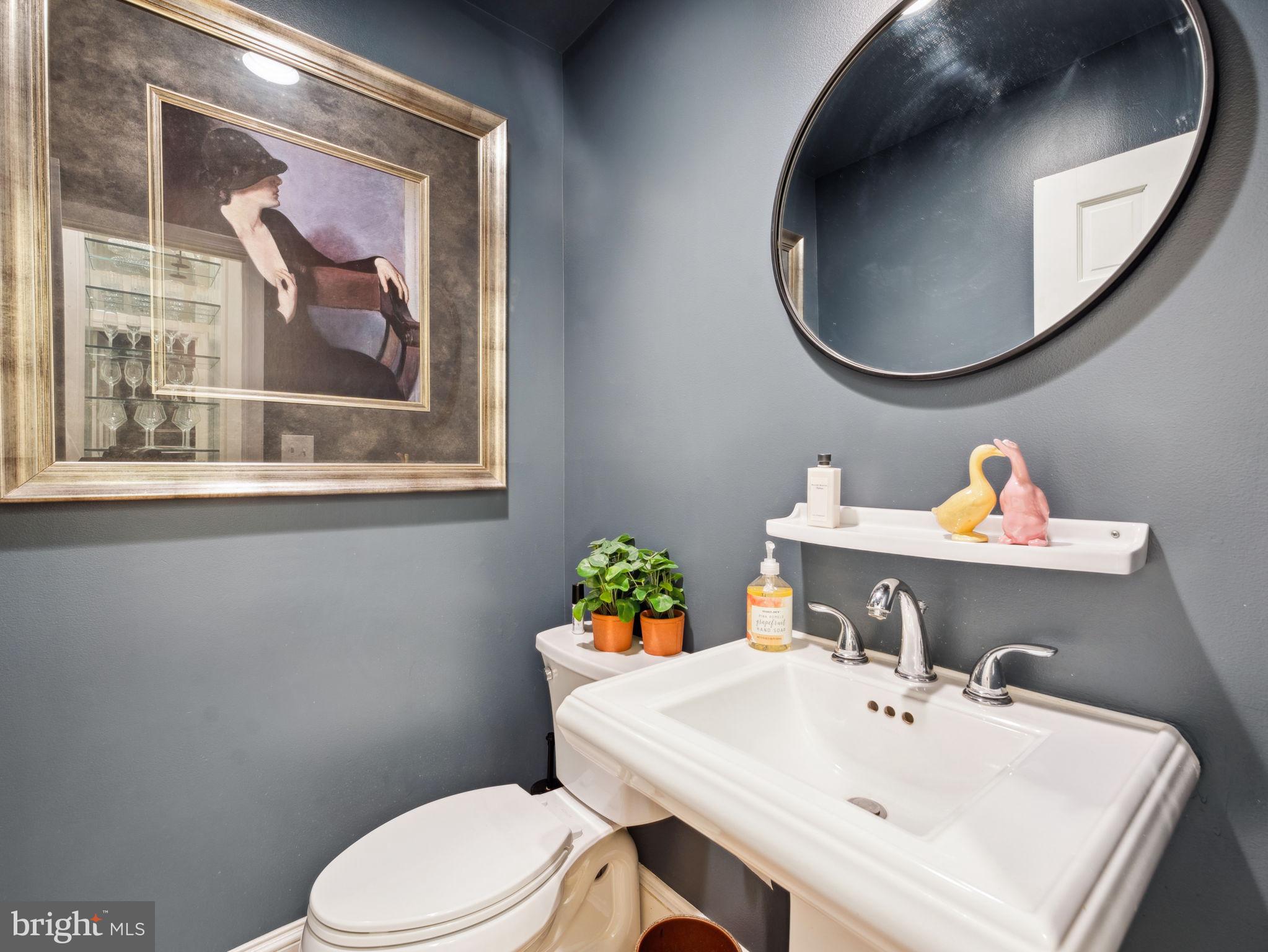 2001 19th Street Northwest, Unit 4 Washington, DC 20009 - Photo 19 of 42 a bathroom with a sink a mirror and a toilet