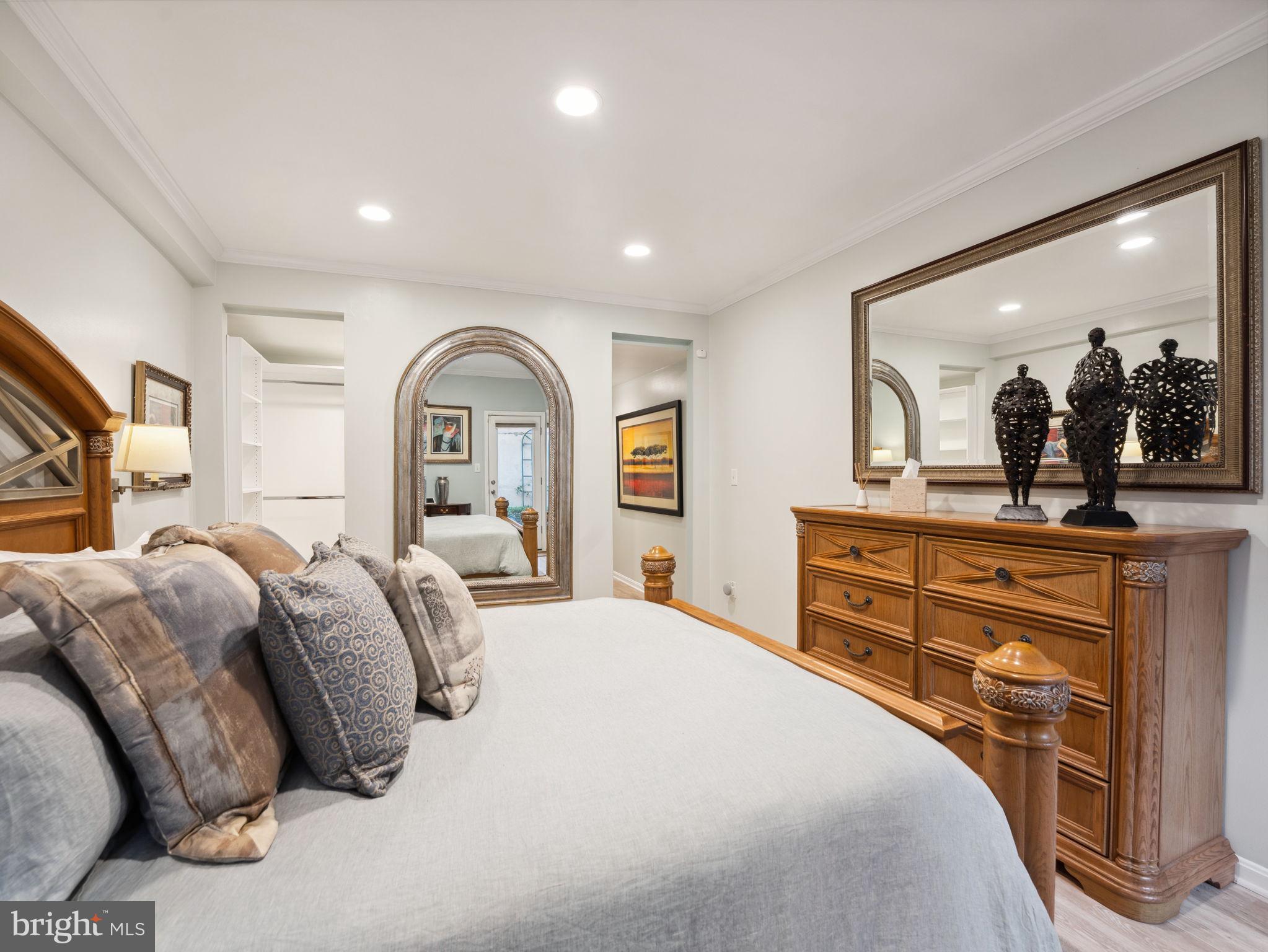 2001 19th Street Northwest, Unit 4 Washington, DC 20009 - Photo 24 of 42 a bedroom with a large bed and a mirror