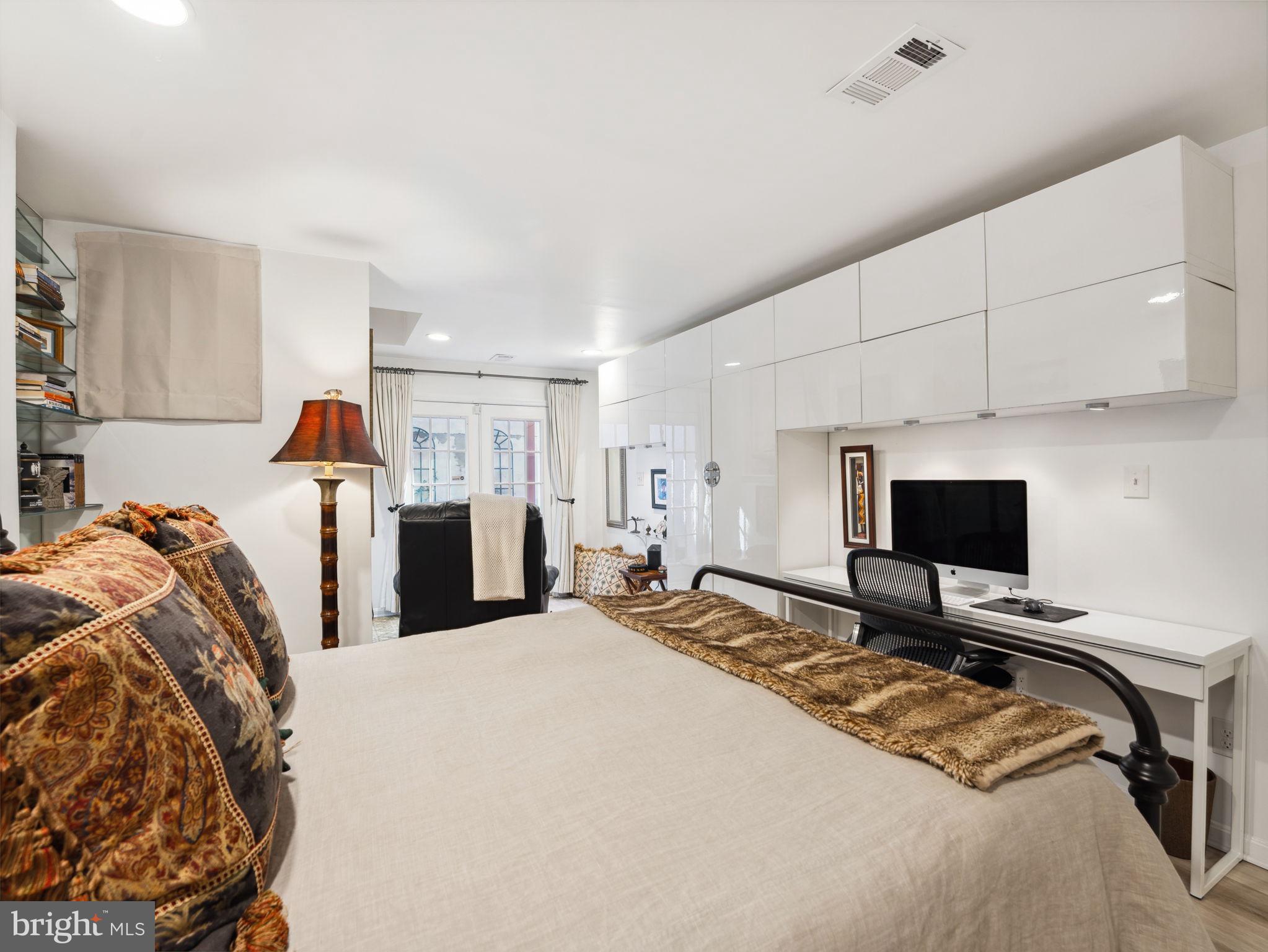 2001 19th Street Northwest, Unit 4 Washington, DC 20009 - Photo 29 of 42 a bedroom with a bed and a desk