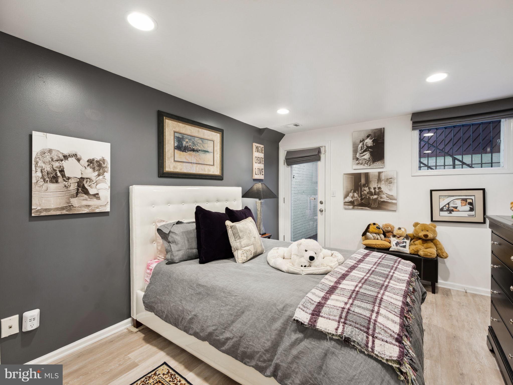 2001 19th Street Northwest, Unit 4 Washington, DC 20009 - Photo 32 of 42 a bedroom with a bed and wooden floor