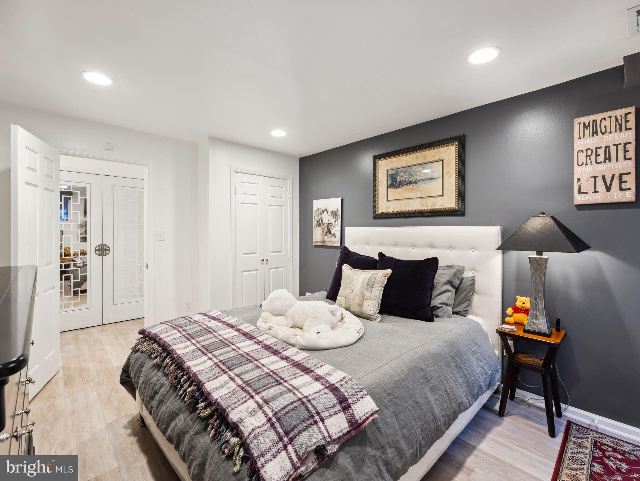2001 19th Street Northwest, Unit 4 Washington, DC 20009 - Photo 33 of 42 a bedroom with a bed and wooden floor