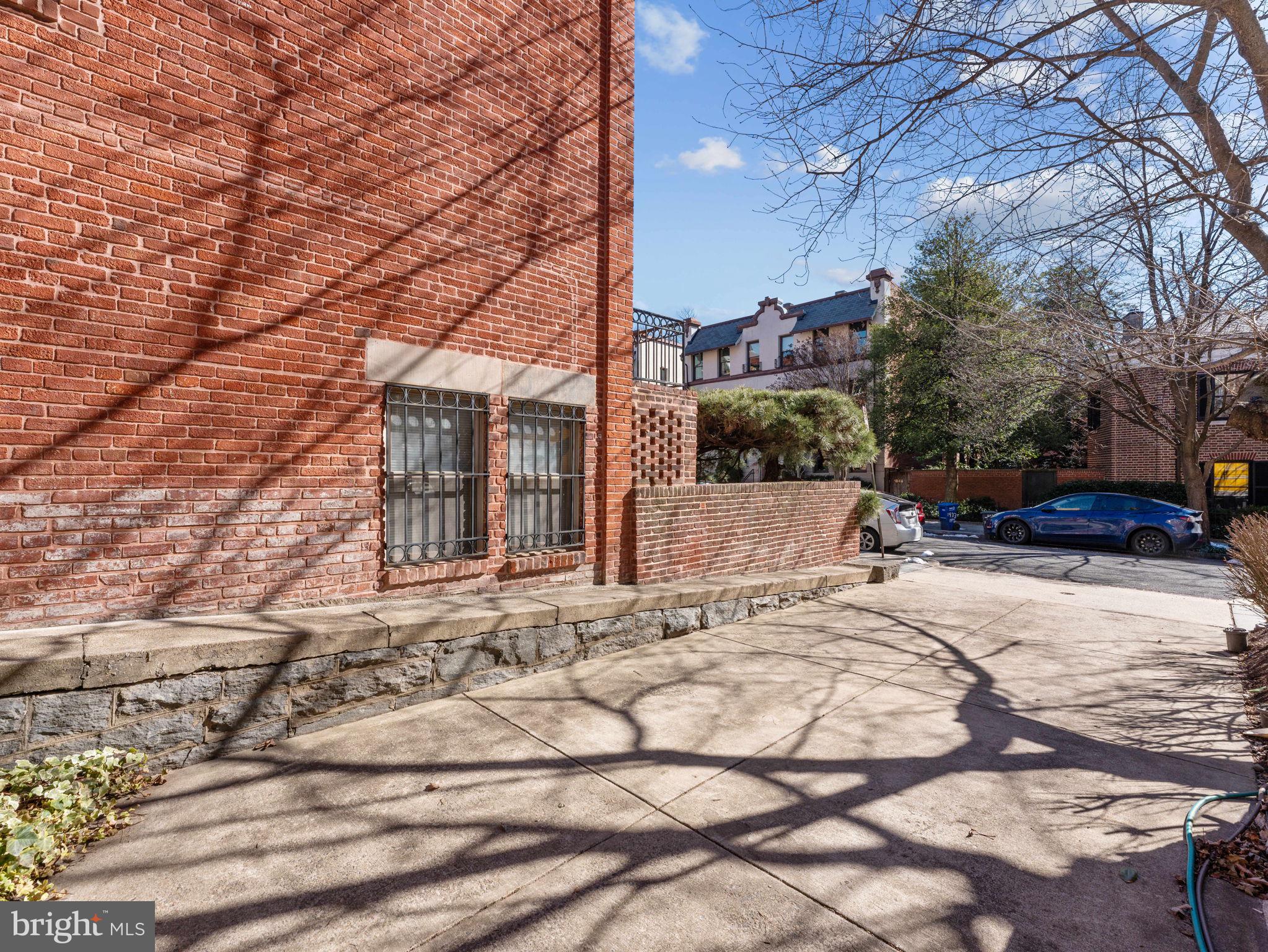 2001 19th Street Northwest, Unit 4 Washington, DC 20009 - Photo 38 of 42 a view of a white house with a yard covered in snow