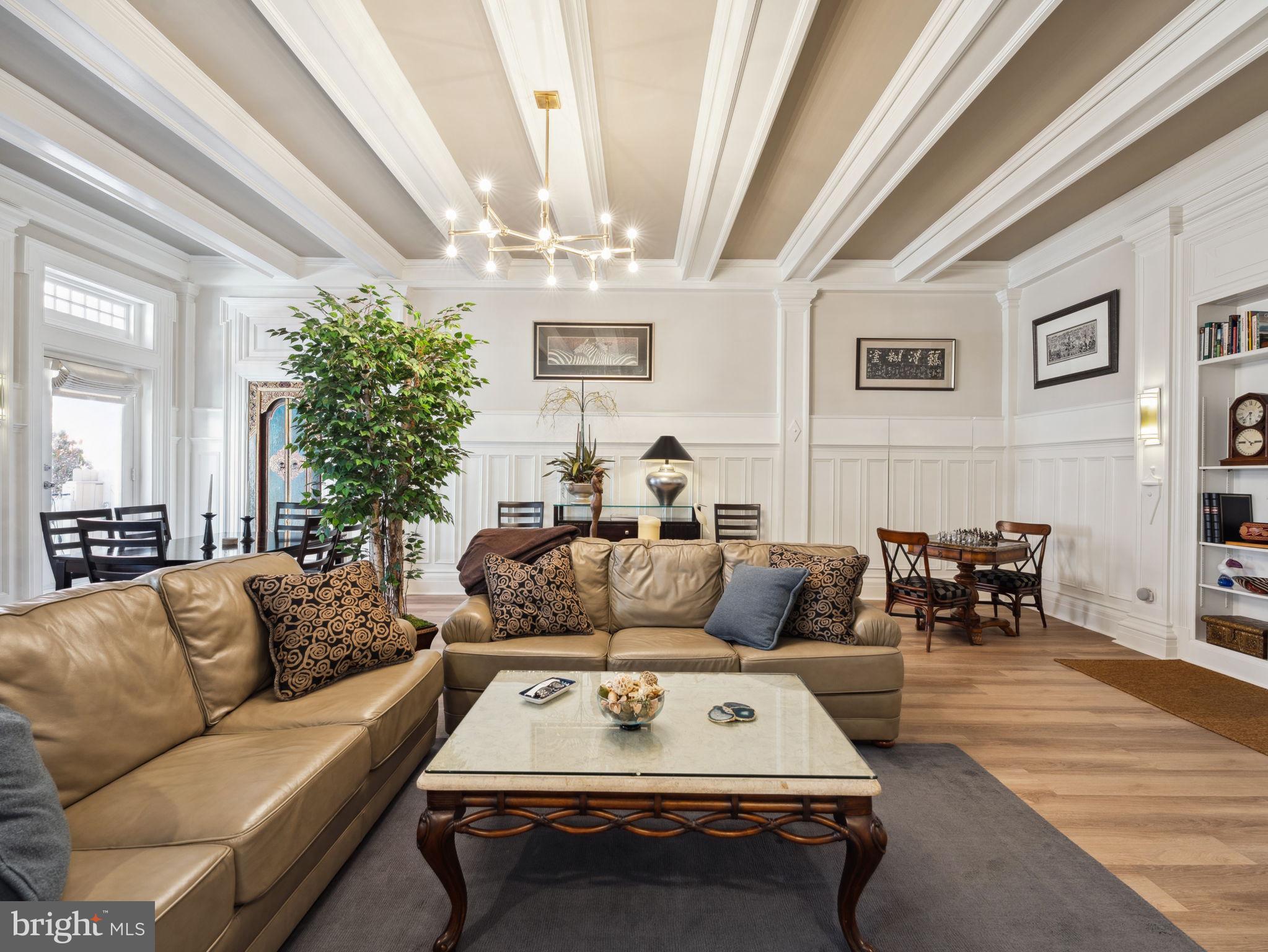 2001 19th Street Northwest, Unit 4 Washington, DC 20009 - Photo 5 of 42 a living room with furniture and a chandelier
