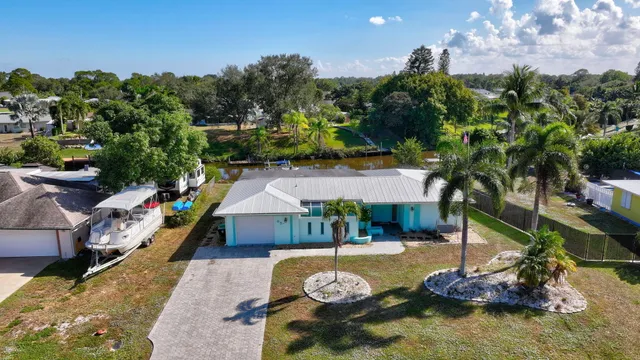 a view of a swimming pool with a patio and a yard