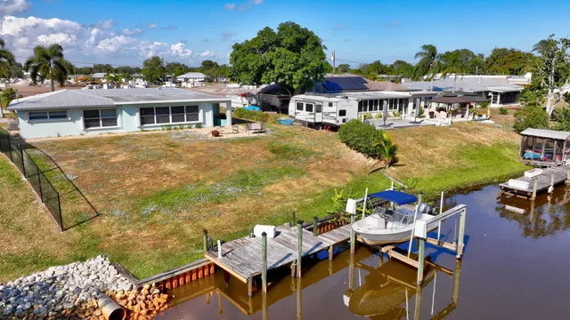 a view of a patio with table and chairs with wooden floor and fence