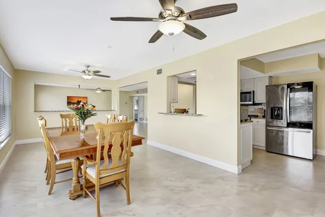 a view of a dining room and livingroom with furniture wooden floor