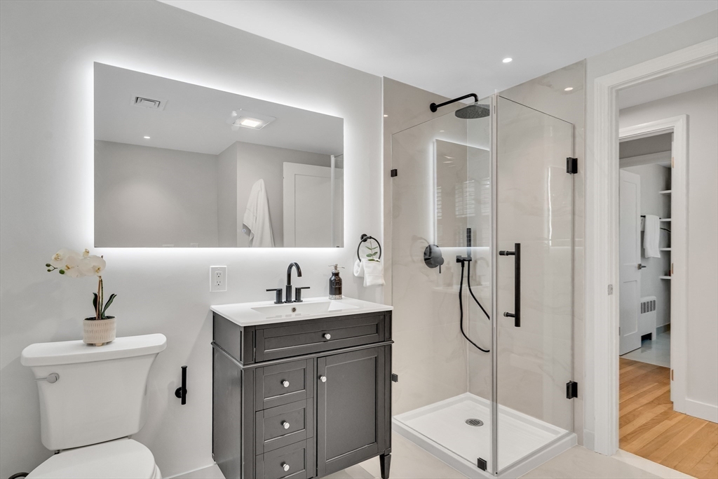 544 Pearl Street Reading, MA 01867 - Photo 11 of 24 a bathroom with a toilet sink and shower
