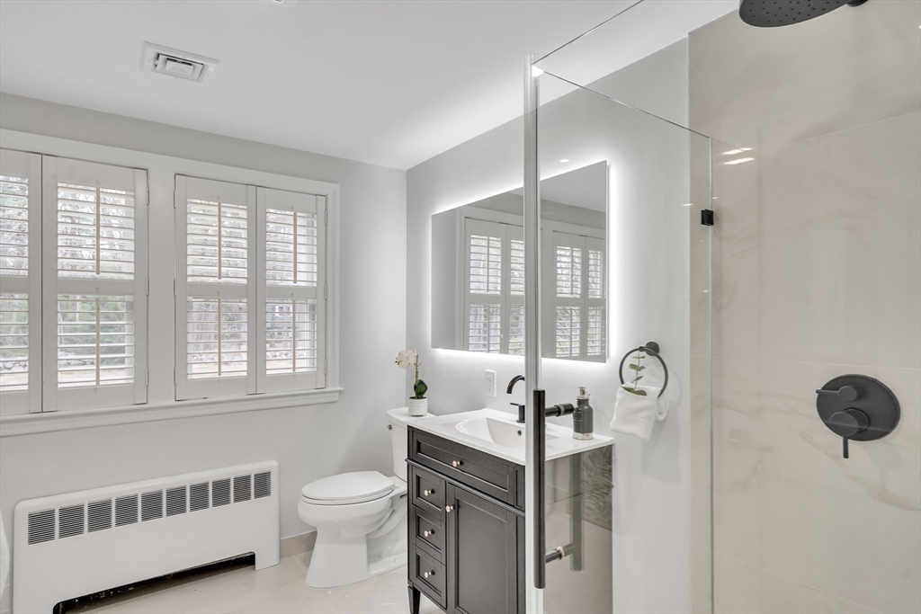 544 Pearl Street Reading, MA 01867 - Photo 12 of 24 a bathroom with a sink vanity granite tub and shower