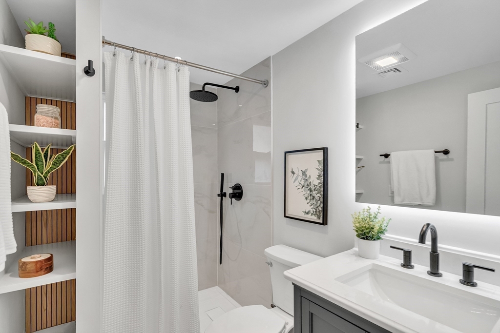544 Pearl Street Reading, MA 01867 - Photo 14 of 24 a bathroom with a sink toilet and shower