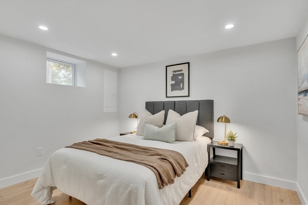544 Pearl Street Reading, MA 01867 - Photo 16 of 24 a bedroom with a bed and a lamp